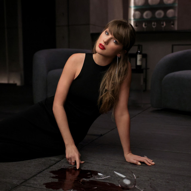 Taylor Swift seated beside a piano, with the square composition preserved